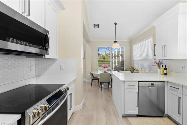 a kitchen with a sink a microwave and cabinets