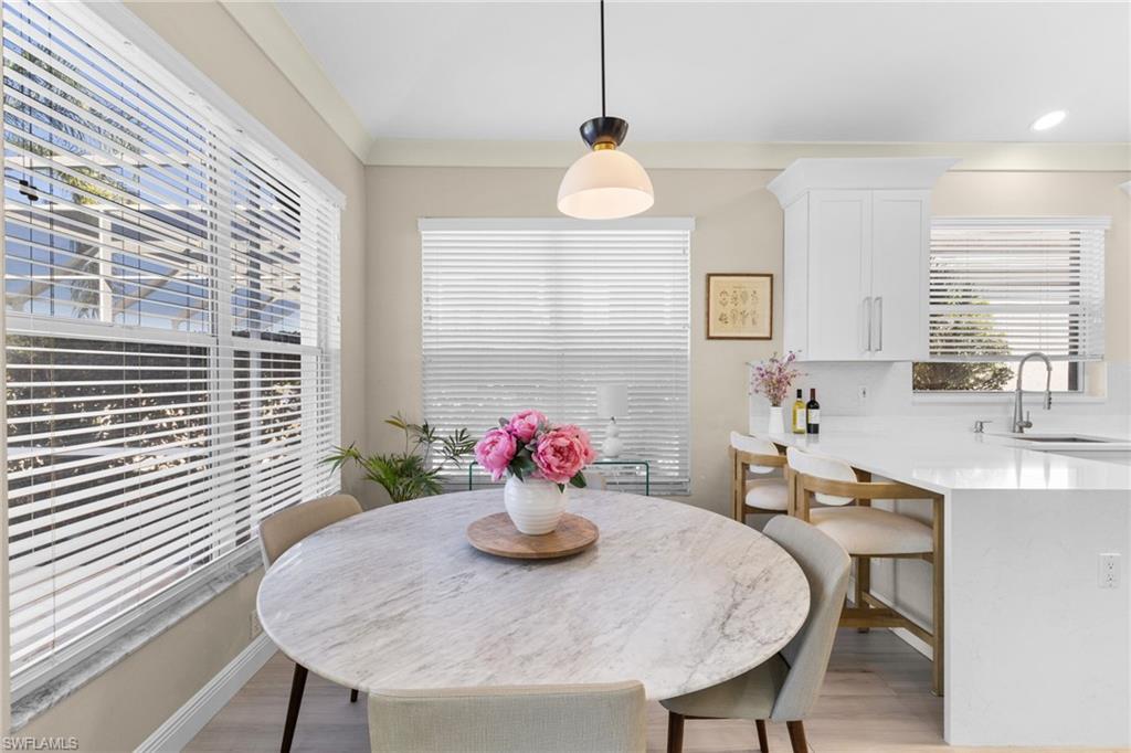 1869 Pondside Lane Naples, FL 34109 - Photo 16 of 34 Dining space with light wood-style floors and baseboards