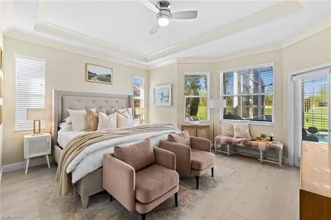 a spacious bedroom with a bed and glass window