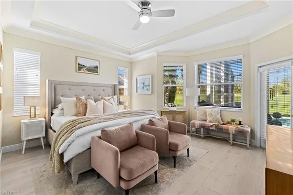 a spacious bedroom with a bed and glass window