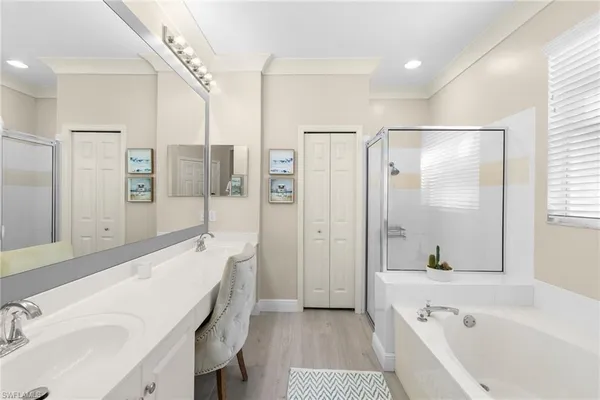 a bathroom with a bathtub shower sink and mirror