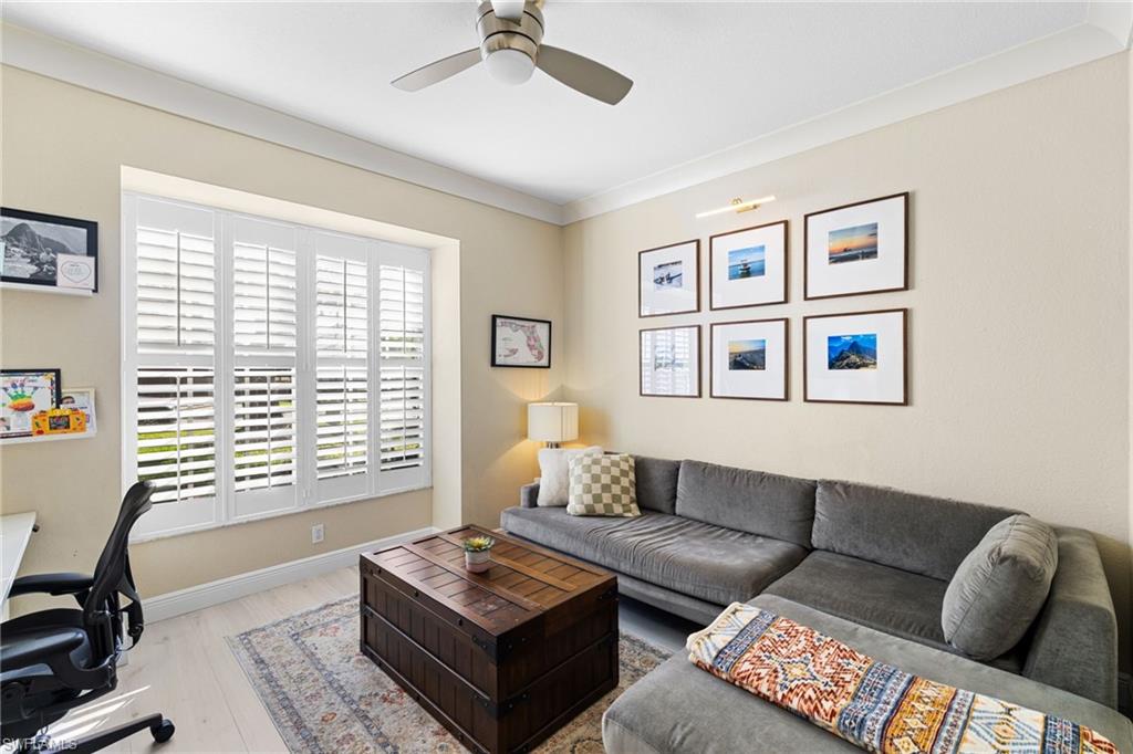 1869 Pondside Lane Naples, FL 34109 - Photo 24 of 34 Living area featuring wood finished floors, ceiling fan, an office area, and crown molding