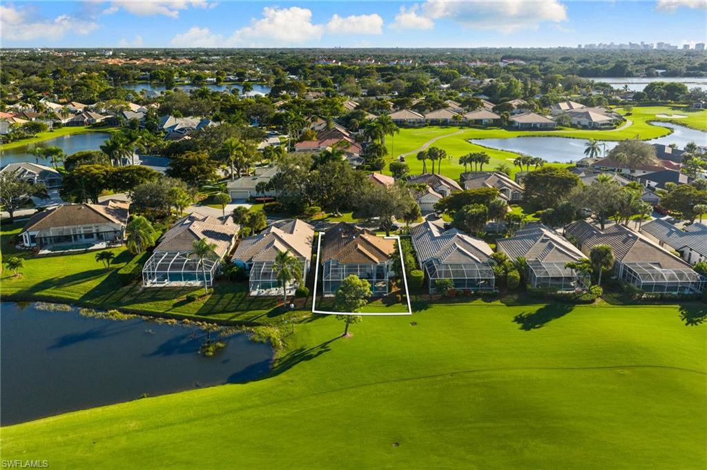 1869 Pondside Lane Naples, FL 34109 - Photo 27 of 34 Aerial perspective of suburban area with a large body of water and a golf course