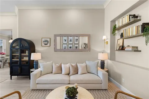 a living room with furniture a rug and a window