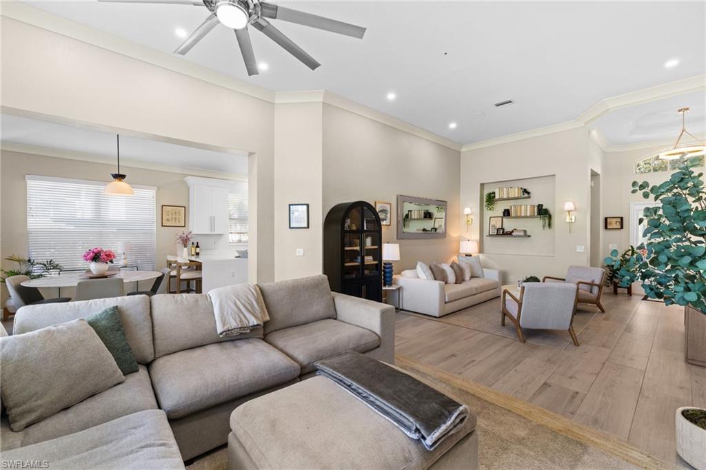 1869 Pondside Lane Naples, FL 34109 - Photo 8 of 34 Living area with ornamental molding, wood finished floors, ceiling fan, and recessed lighting