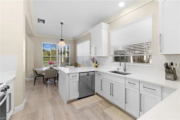 a kitchen with sink cabinets and window