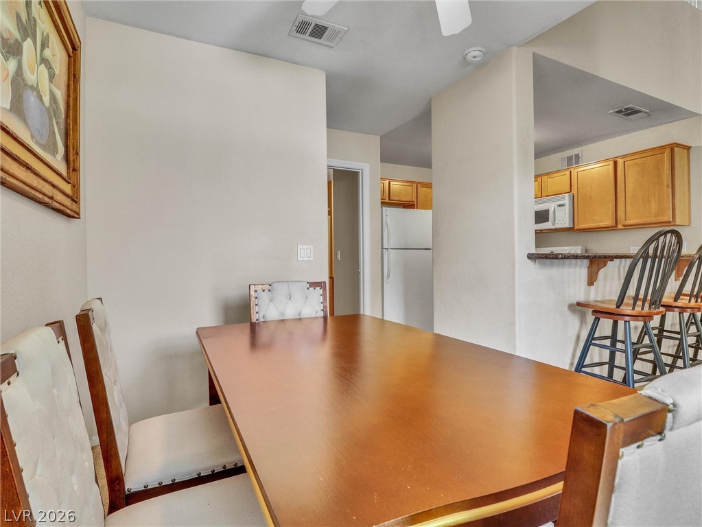 3145 East Flamingo Road, Unit 2129 Las Vegas, NV 89121 - Photo 12 of 43 A well-appointed dining space flows seamlessly into a functional kitchen area.