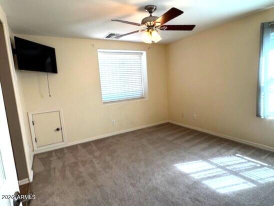 3827 East Trigger Way Gilbert, AZ 85297 - Photo 22 of 41 an empty room with windows and fan