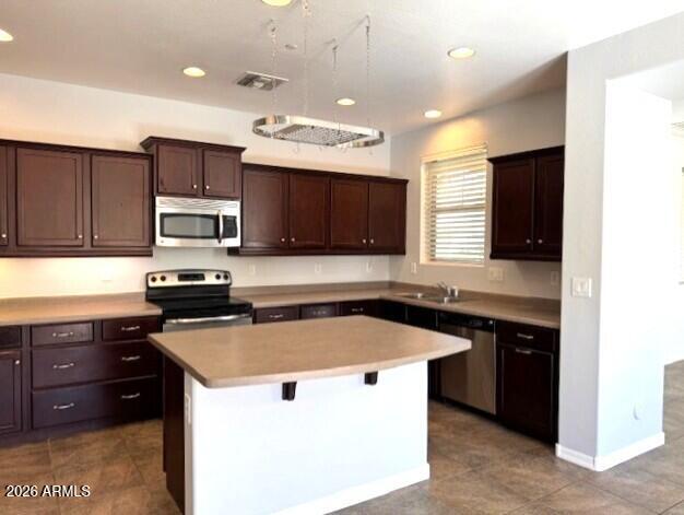3827 East Trigger Way Gilbert, AZ 85297 - Photo 9 of 41 a kitchen with a sink and a microwave