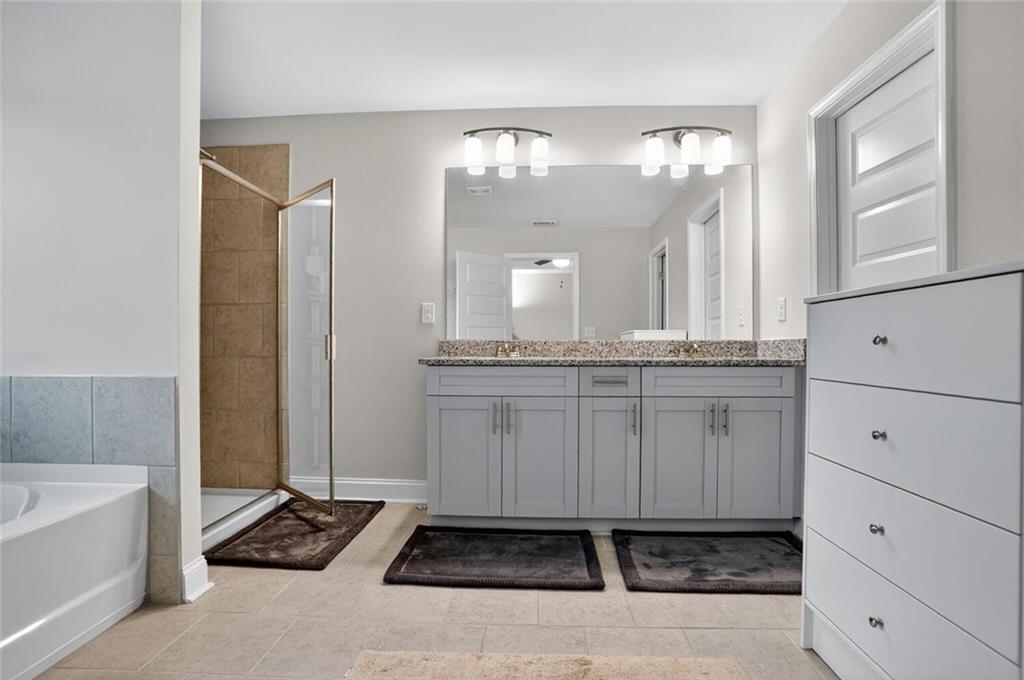 2805 Harmony Trail Road Atlanta, GA 30360 - Photo 14 of 23 a bathroom with a double vanity sink a mirror and a bathtub
