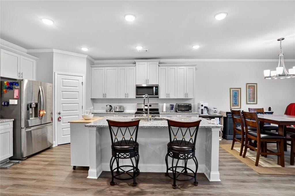 2805 Harmony Trail Road Atlanta, GA 30360 - Photo 4 of 23 a view of kitchen with stainless steel appliances granite countertop dining table chairs refrigerator and microwave