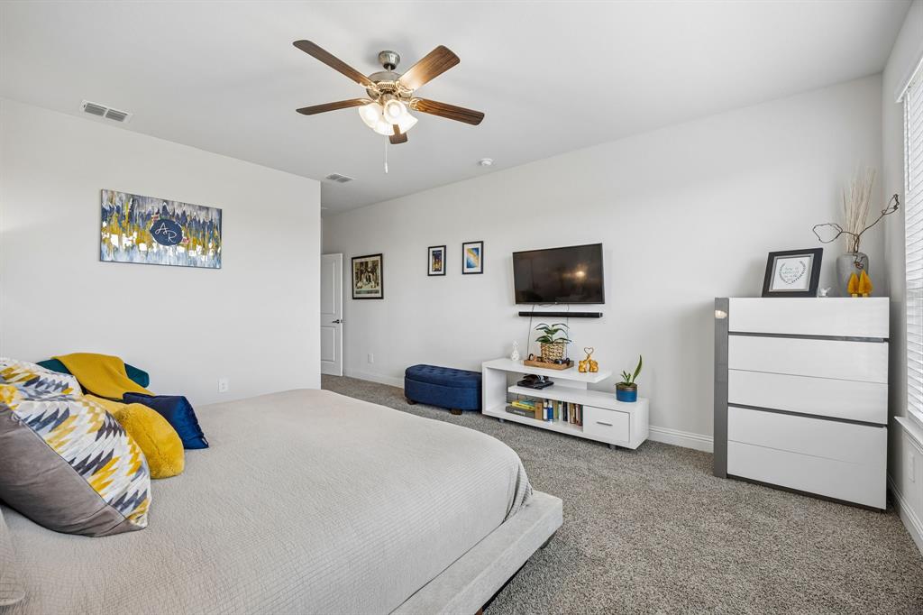 425 Breeds Hl Road Little Elm, TX 75068 - Photo 13 of 38 a bedroom with a bed and a tv