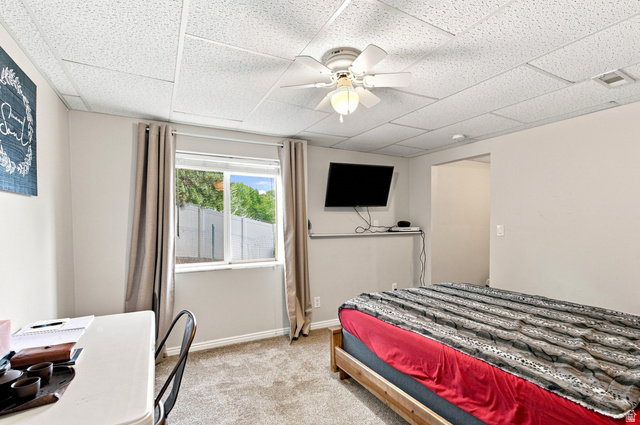 11882 Pond Ridge Drive Draper, UT 84020 - Photo 33 of 49 Drop ceiling with recessed lighting, ceiling fan, wall-mounted television, and wood-frame bed