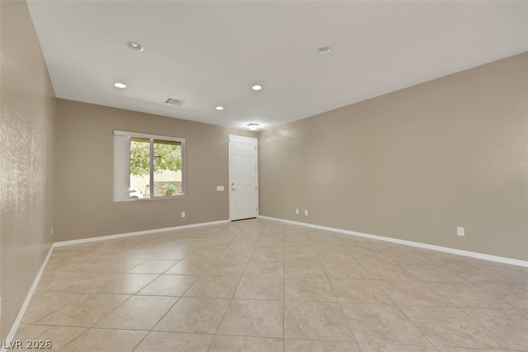 2501 Bechamel Place Henderson, NV 89044 - Photo 4 of 50 A spacious, open interior with warm-toned walls and durable tile flooring.
