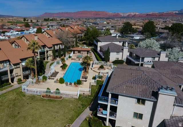 860 South Village Road, Unit H1 St. George, UT 84770 - Photo 17 of 20 Aerial view of residential area with a mountainous background