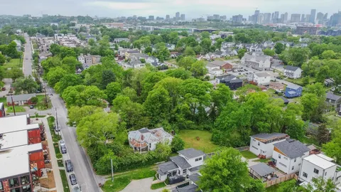 an aerial view of a house with garden space and street view