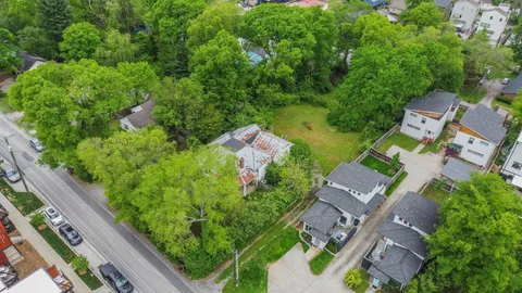 an aerial view of a house with a yard