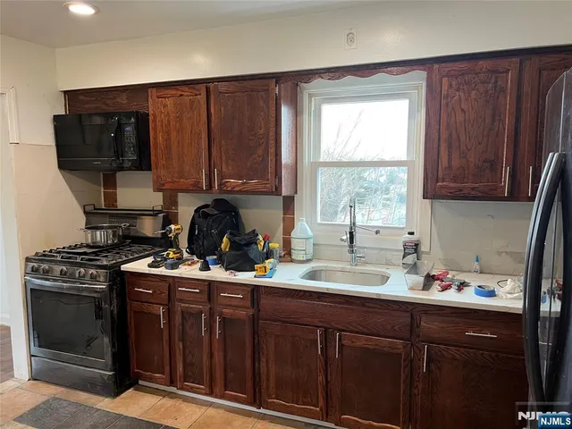 a kitchen with wooden floors and appliances