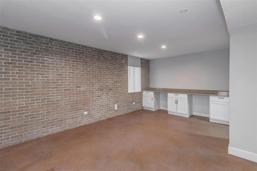 4930 Thunder Road Dallas, TX 75244 - Photo 11 of 23 Exposed brick wall with built-in cabinetry, counter space, and recessed lighting