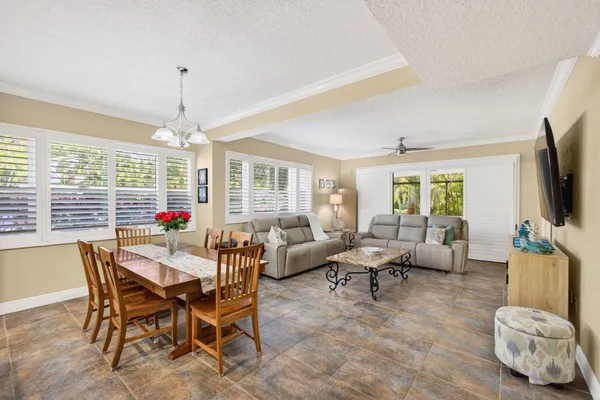 a kitchen with stainless steel appliances kitchen island granite countertop a sink a stove and a wooden floors