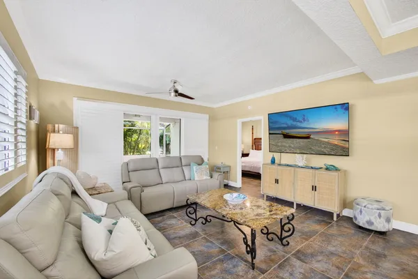 a kitchen that has a sink a stove and a table in it