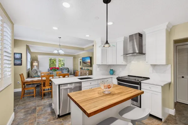a kitchen with a sink and white cabinets
