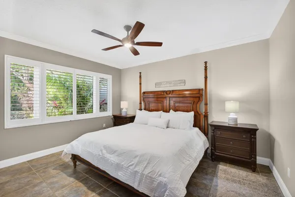 a bedroom with a large bed and a window