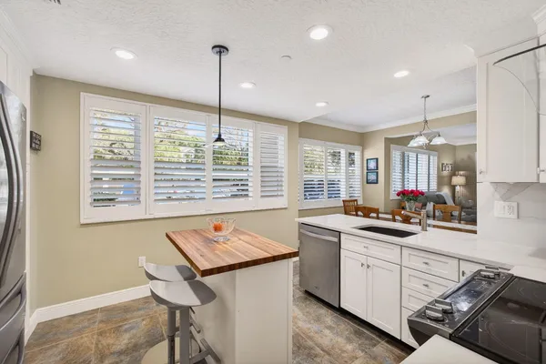 a living room with furniture and floor to ceiling windows