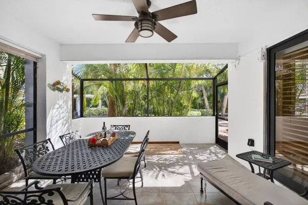 a living room with furniture and floor to ceiling windows