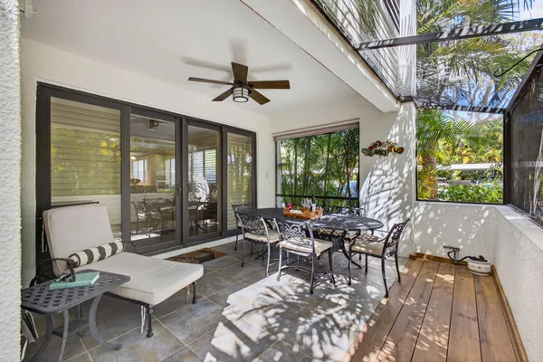 a view of a backyard with chair and potted plants
