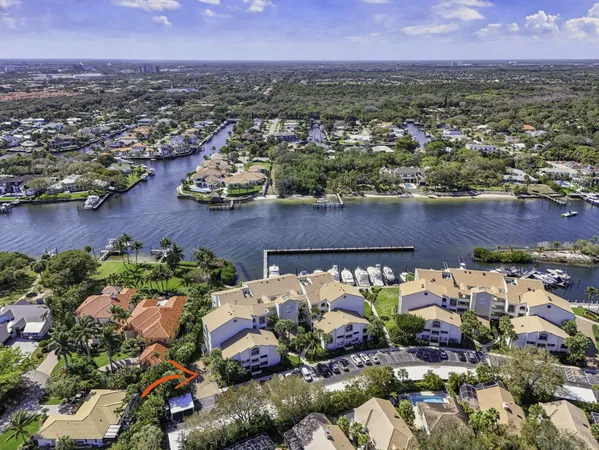 an aerial view of residential houses with outdoor space and street view