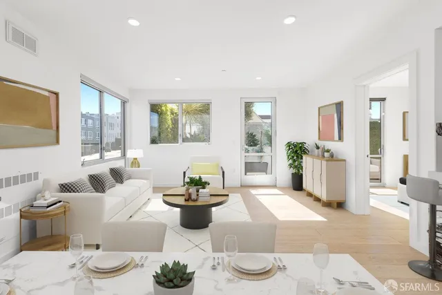 a living room with furniture and a potted plant
