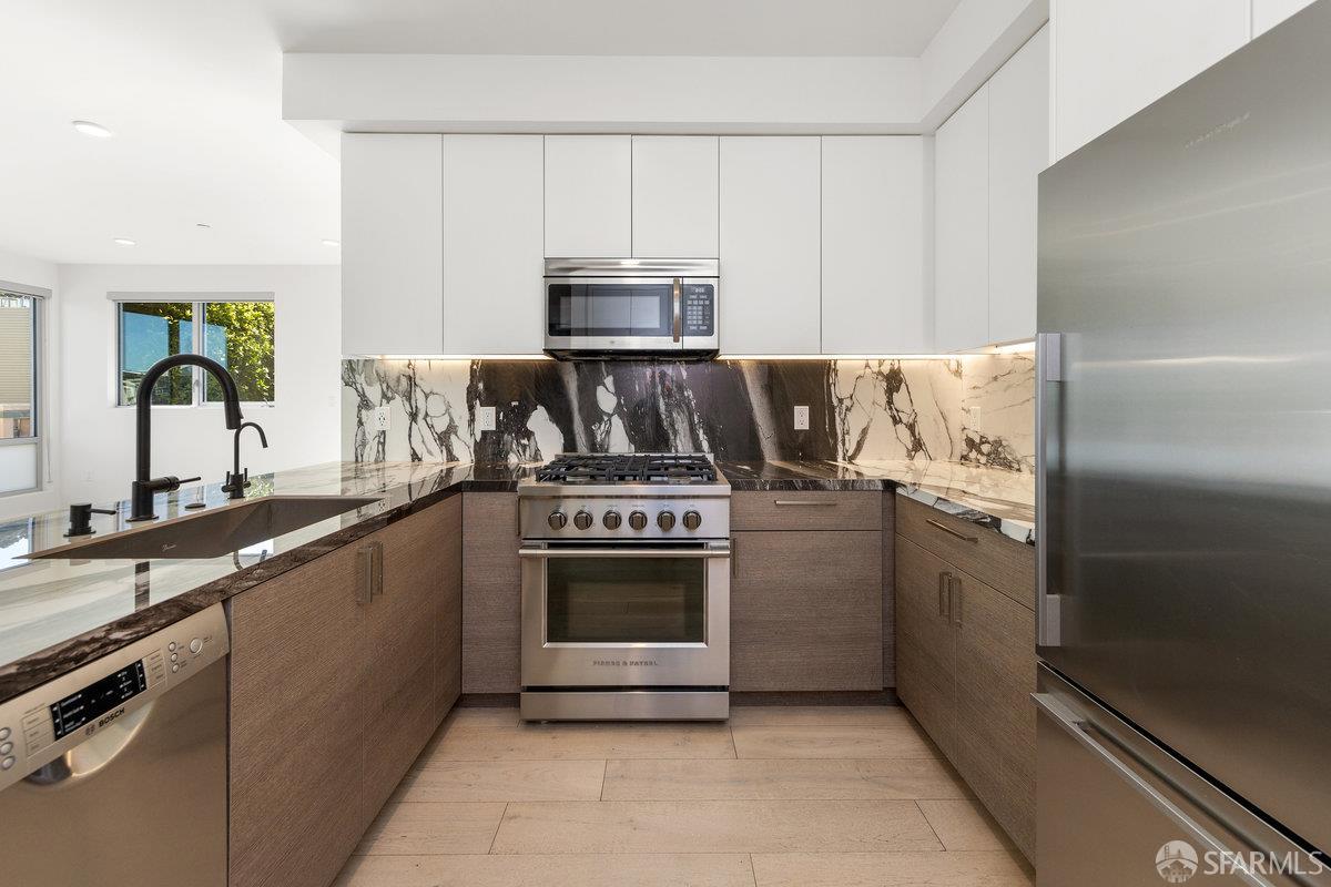 1 Stanyan Street, Unit 24 San Francisco, CA 94118 - Photo 25 of 51 a kitchen with granite countertop a stove sink and refrigerator