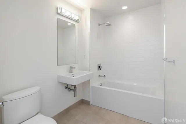 a bathroom with a bathtub a sink and a mirror