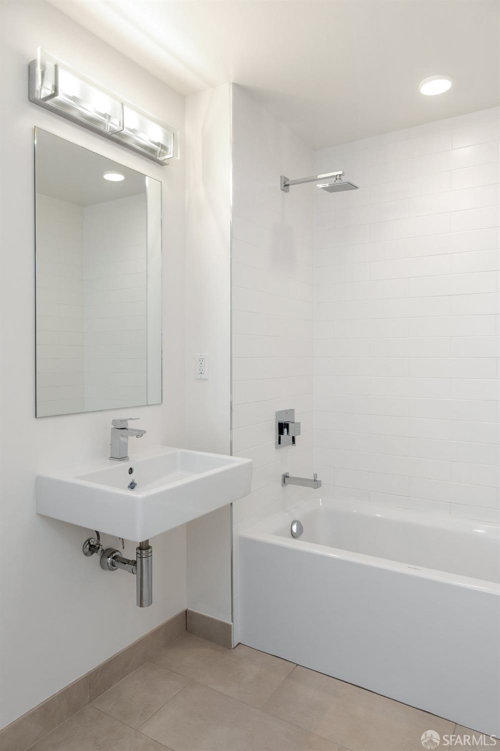 1 Stanyan Street, Unit 24 San Francisco, CA 94118 - Photo 29 of 51 a bathroom with a bathtub a sink and a mirror