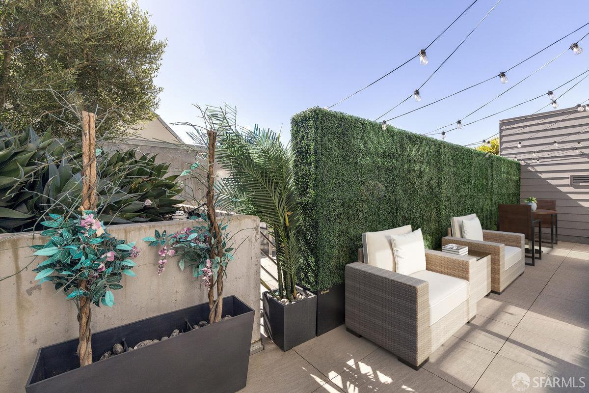 1 Stanyan Street, Unit 24 San Francisco, CA 94118 - Photo 5 of 51 a view of a patio with couches and a table and chairs with wooden floor