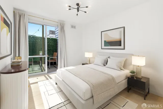 a bedroom with a bed and a large window