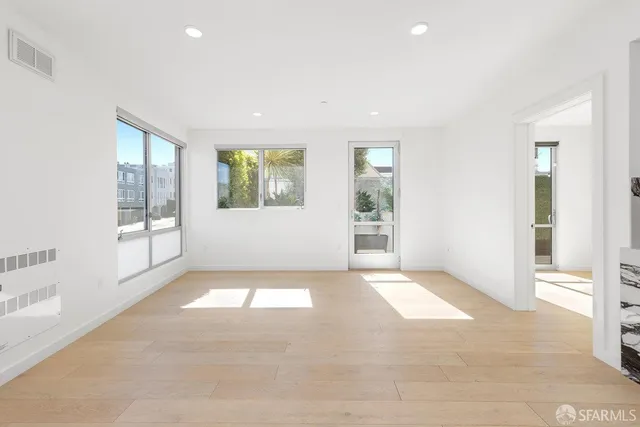 an empty room with windows and entrance