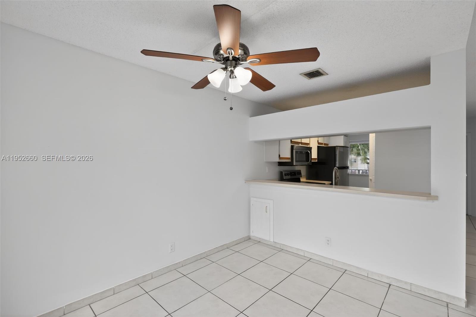 13856 Southwest 93rd Lane, Unit 13856 Miami, FL 33186 - Photo 14 of 37 a view of empty room with a ceiling fan
