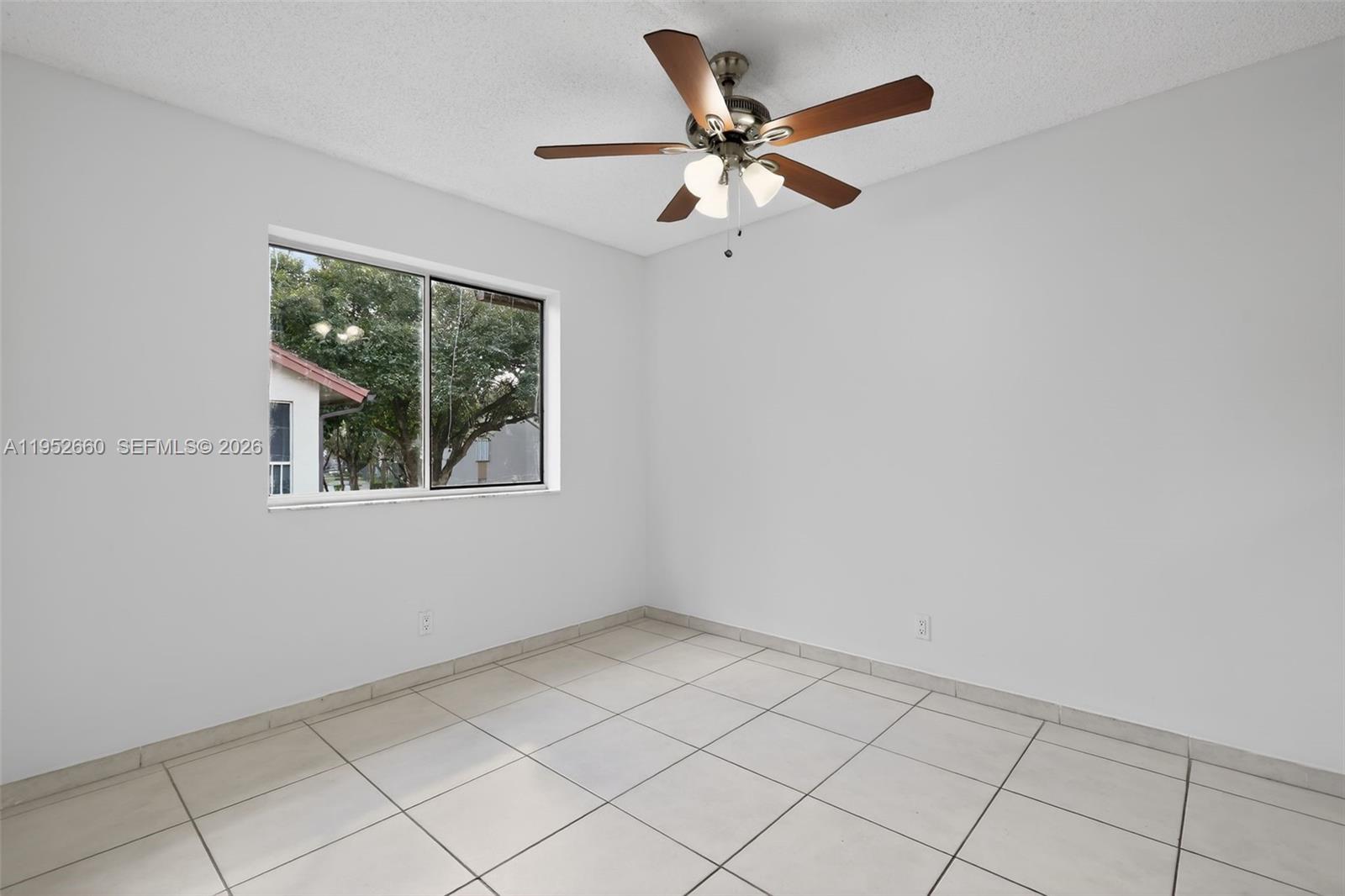 13856 Southwest 93rd Lane, Unit 13856 Miami, FL 33186 - Photo 15 of 37 a view of an empty room with a window