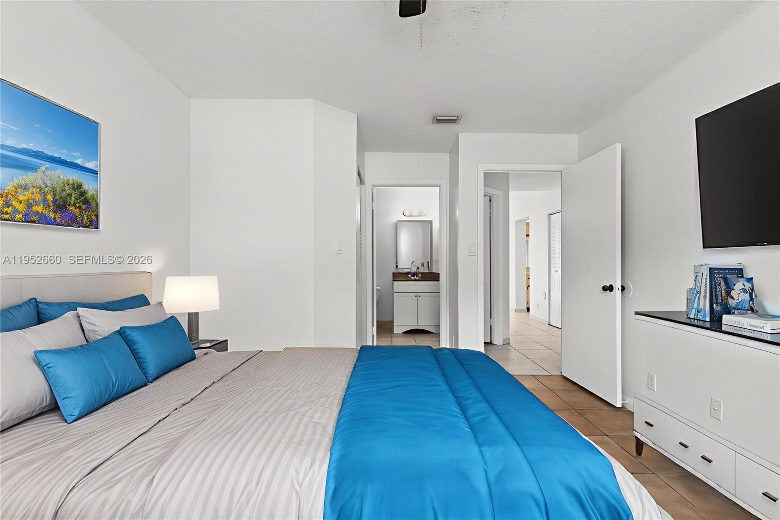 13856 Southwest 93rd Lane, Unit 13856 Miami, FL 33186 - Photo 23 of 37 a bedroom with a bed and a flat screen tv