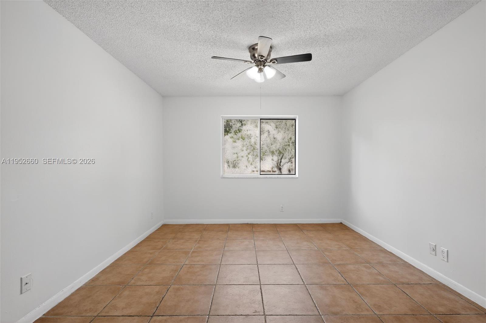 13856 Southwest 93rd Lane, Unit 13856 Miami, FL 33186 - Photo 27 of 37 a view of an empty room with a window