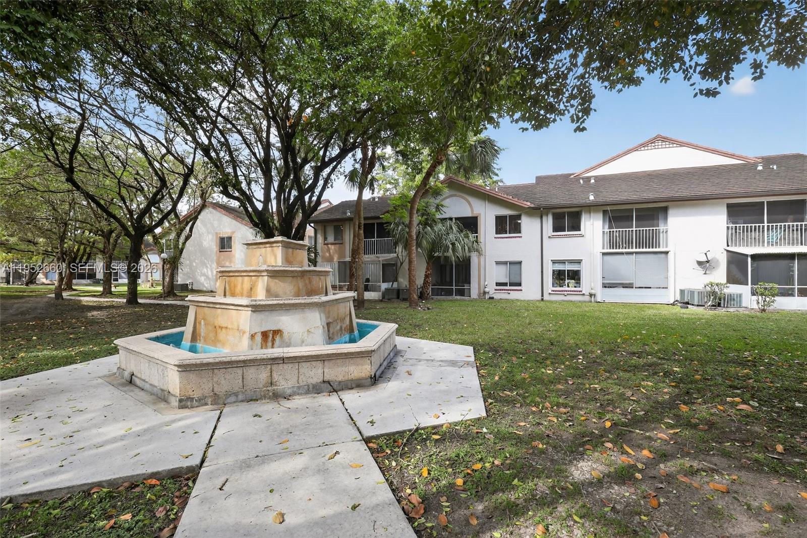 13856 Southwest 93rd Lane, Unit 13856 Miami, FL 33186 - Photo 31 of 37 a front view of a house with a yard