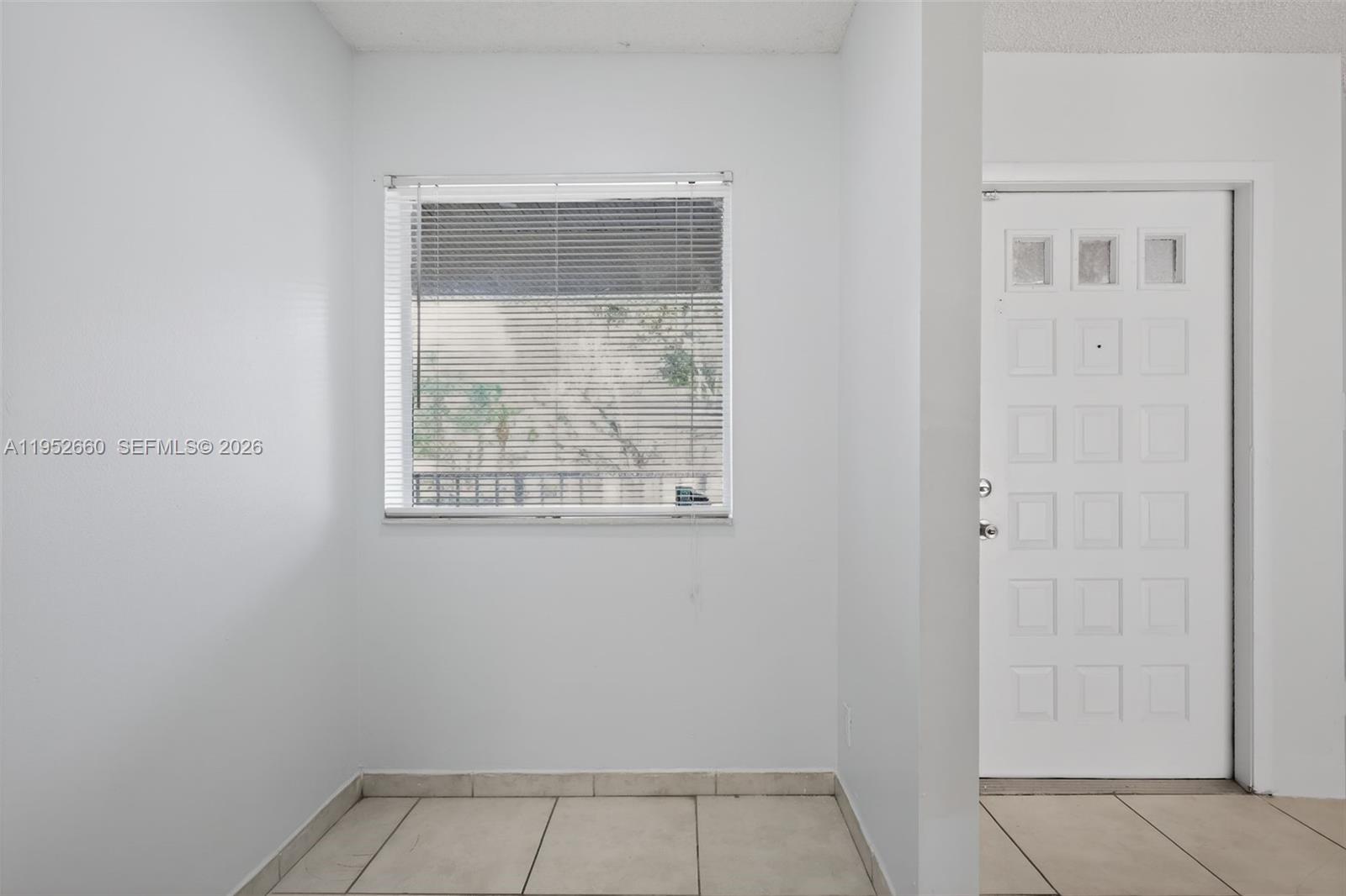 13856 Southwest 93rd Lane, Unit 13856 Miami, FL 33186 - Photo 6 of 37 an empty room with a window