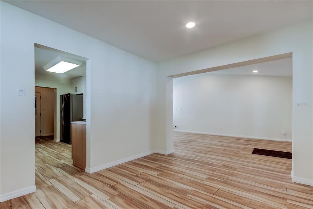 3936 East Eden Roc Circle Tampa, FL 33634 - Photo 11 of 68 a view of a room with wooden floor and staircase