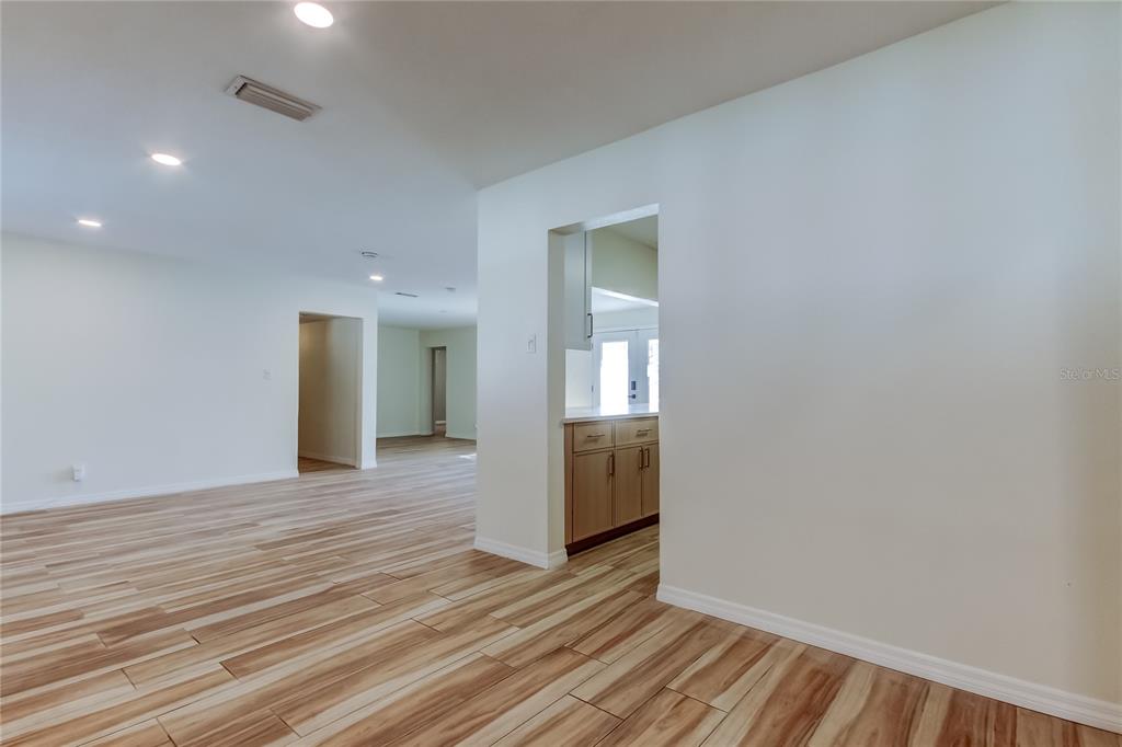 3936 East Eden Roc Circle Tampa, FL 33634 - Photo 12 of 68 a view of a hallway with wooden floor and a bathroom