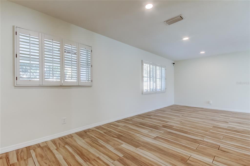 3936 East Eden Roc Circle Tampa, FL 33634 - Photo 13 of 68 a view of empty room with wooden floor and fan
