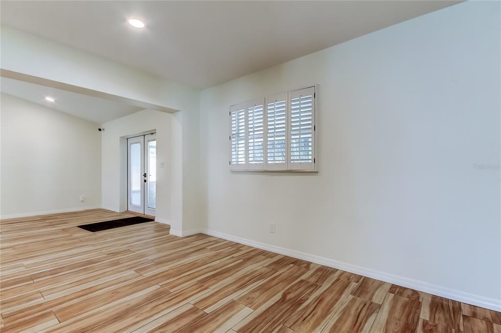 3936 East Eden Roc Circle Tampa, FL 33634 - Photo 14 of 68 a view of a livingroom with wooden floor and a window