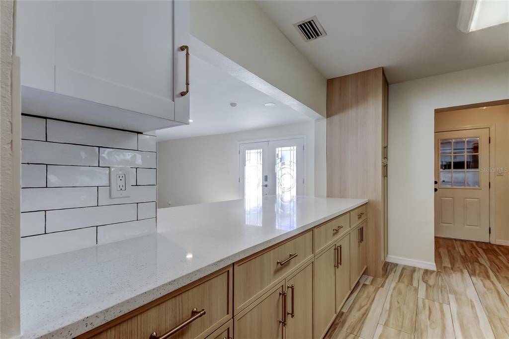 3936 East Eden Roc Circle Tampa, FL 33634 - Photo 16 of 68 a view of a walk in closet and wooden floor
