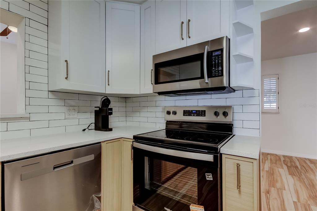 3936 East Eden Roc Circle Tampa, FL 33634 - Photo 18 of 68 a kitchen with a stove and a microwave
